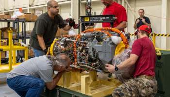 Sikorsky team members remove a recently delivered GE T901 engine from its shipping crate at the Sikorsky facility in West Palm Beach, Florida, on Oct. 20. U.S. Army Photo