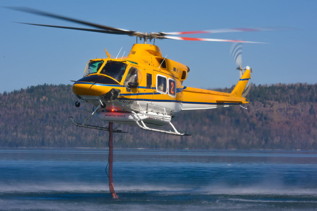 A 412 refills during wildfire training. The operator recently won a seven-year contract from the Ontario Ministry of Natural Resources and Forestry to provide firefighting support with two 412s. Mike Reyno Photo